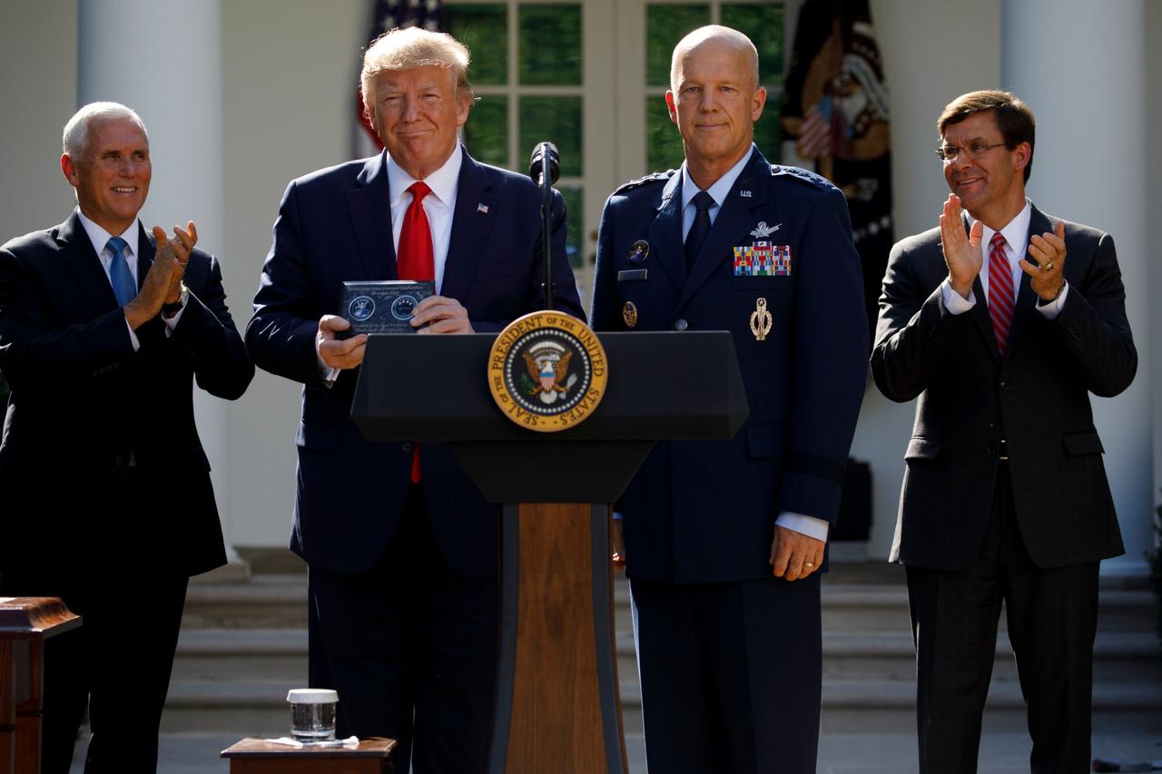 Air Force Gen. John "Jay" Raymond stands with President Donald Trump during a ceremony to establish the US Space Command last August, via AP.